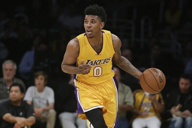 Los Angeles Lakers' Nick Young dribbles down the court during the first half of an NBA basketball game against the Denver Nuggets on Tuesday, Feb. 10, 2015, in Los Angeles. (AP Photo/Jae C. Hong)