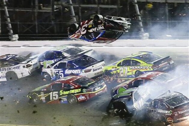 Austin Dillon (3) goes airborne and hits the catch fence as he was involved in a multi-car crash on the final lap of the NASCAR Sprint Cup series auto race at Daytona International Speedway, Monday, July 6, 2015, in Daytona Beach, Fla. (AP Photo/Terry Renna)