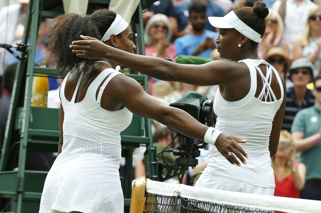 Serena Williams of the United States, left hugs her sister Venus Williams of the United States after winning their singles match, at the All England Lawn Tennis Championships in Wimbledon, London, Monday July 6, 2015. Serena Williams won 6-4, 6-3. (AP Photo/Alastair Grant)