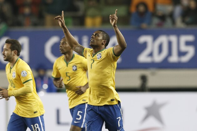 Brazil's Douglas Costa, center, celebrates his goal against Peru during a Copa America Group C soccer match at the German Becker stadium in Temuco, Chile, Sunday, June 14, 2015. (AP Photo/Silvia Izquierdo)