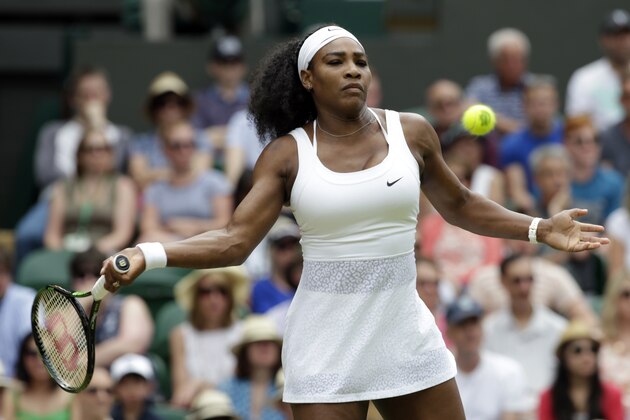 Serena Williams of the United States makes a return to Venus Williams of the United States,  during their singles match against at the All England Lawn Tennis Championships in Wimbledon, London, Monday July 6, 2015. (AP Photo/Alastair Grant)