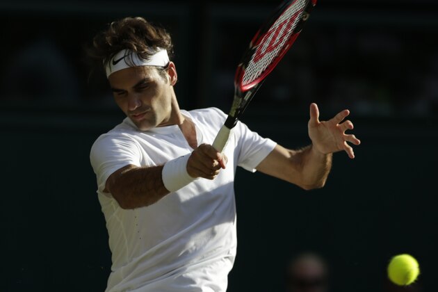 Roger Federer of Switzerland returns a ball to  Roberto Bautista Agut of Spain during their singles match against at the All England Lawn Tennis Championships in Wimbledon, London, Monday July 6, 2015. (AP Photo/Alastair Grant)