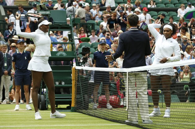 Serena Williams of the United States, right and her sister Venus Williams of the United States  stretch ahead of their singles match, at the All England Lawn Tennis Championships in Wimbledon, London, Monday July 6, 2015. (AP Photo/Alastair Grant)