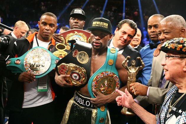 May 2, 2015; Las Vegas, NV, USA; Floyd Mayweather Jr celebrates with the championship belts after defeating Manny Pacquiao (not pictured) after 12 rounds in a unanimous judges decision during a boxing fight at the MGM Grand Garden Arena. Mandatory Credit: Mark J. Rebilas-USA TODAY Sports