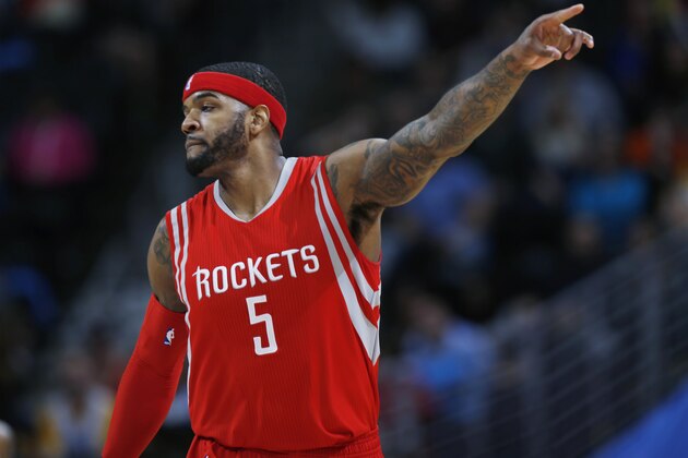 Houston Rockets forward Josh Smith acknowledges his teammates after scoring against the Denver Nuggets during the third quarter of an NBA basketball game Saturday, March 7, 2015, in Denver. Houston won 114-100. (AP Photo/David Zalubowski)