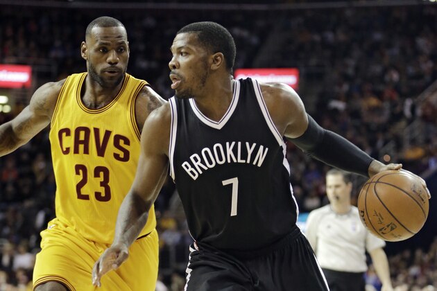 Brooklyn Nets' Joe Johnson (7) drives past Cleveland Cavaliers' LeBron James (23) during an NBA basketball game Wednesday, March 18, 2015, in Cleveland. (AP Photo/Tony Dejak)