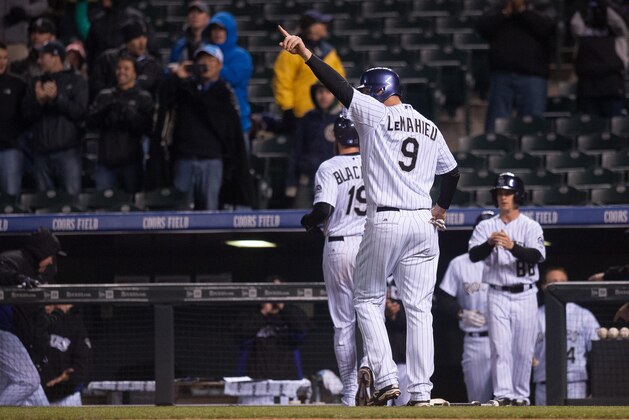 DENVER, CO - MAY 19:  DJ LeMahieu #9 of the Colorado Rockies points to Troy Tulowitzki #2 of the Colorado Rockies (not pictured) to celebrate after scoring in the seventh inning  at Coors Field on May 19, 2015 in Denver, Colorado.  (Photo by Dustin Bradford/Getty Images)