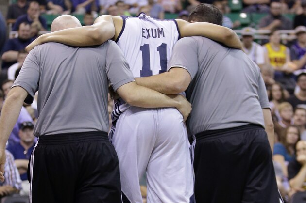 Utah Jazz's Dante Exum (11) is helped off the court after being injured during the second half of an NBA summer league basketball game against the Boston Celtics Monday, July 6, 2015, in Salt Lake City. The Jazz won 100-82. (AP Photo/Rick Bowmer)