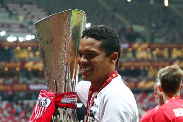 WARSAW, POLAND - MAY 27:  Carlos Bacca of Sevilla celebrates victory with the trophy after the UEFA Europa League Final match between FC Dnipro Dnipropetrovsk and FC Sevilla on May 27, 2015 in Warsaw, Poland.  (Photo by Michael Steele/Getty Images)