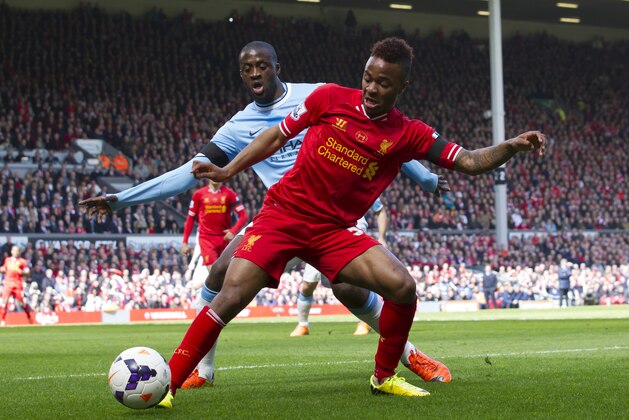 Liverpool's Raheem Sterling, right, keeps the ball from Manchester City's Yaya Toure during their English Premier League soccer match at Anfield Stadium, Liverpool, England, Sunday April 13, 2014. (AP Photo/Jon Super)
