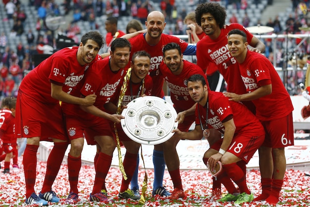 Bayern players hold the trophy as they celebrate winning the Bundesliga title after the German first division Bundesliga soccer match between FC Bayern Munich and FSV Mainz 05 at the Allianz Arena in Munich, Germany, Saturday, May 23, 2015. (AP Photo/Matthias Schrader) Bayern players hold the trophy as they celebrate winning the Bundesliga title after the German first division Bundesliga soccer match between FC Bayern Munich and FSV Mainz 05 at the Allianz Arena in Munich, Germany, Saturday, May 23, 2015. (AP Photo/Matthias Schrader)