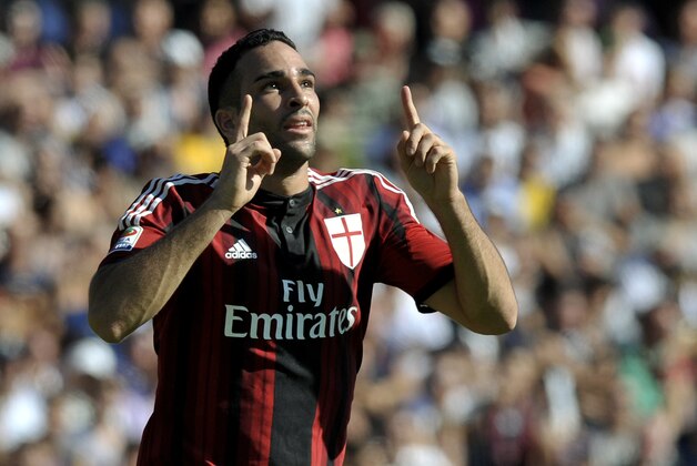 AC Milan's Adil Rami of France celebrates after scoring a goal during a Serie A soccer match against Cesena, at Cesena's Manuzzi stadium, Italy, Sunday, Sept. 28, 2014. (AP Photo/Marco Vasini)