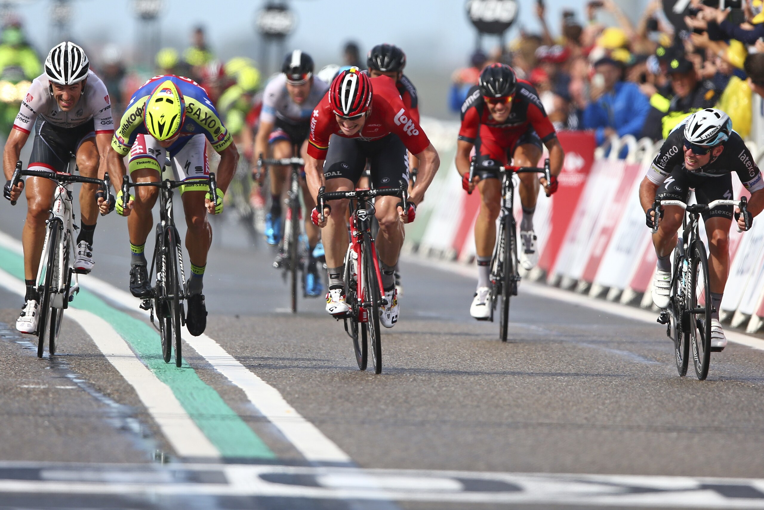 Germany's Andre Greipel, center, crosses the finish line ahead of Peter Sagan of Slovakia, second left and second place, Switzerland's Fabian Cancellara, left and third place, and Britain's sprinter Mark Cavendish, right and fourth place, to win the second stage of the Tour de France cycling race over 166 kilometers (103 miles) with start in Utrecht and finish in Neeltje Jans, Netherlands, Sunday, July 5, 2015. (AP Photo/Peter Dejong)