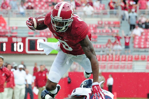 TUSCALOOSA, AL - SEPTEMBER 6: Robert Foster #8 of the Alabama Crimson Tide is upended by Ron Henderson #38 of the Florida Atlantc Owls at Bryant-Denny Stadium on September 6, 2014 in Tuscaloosa, Alabama. (Photo by Scott Cunningham/Getty Images)