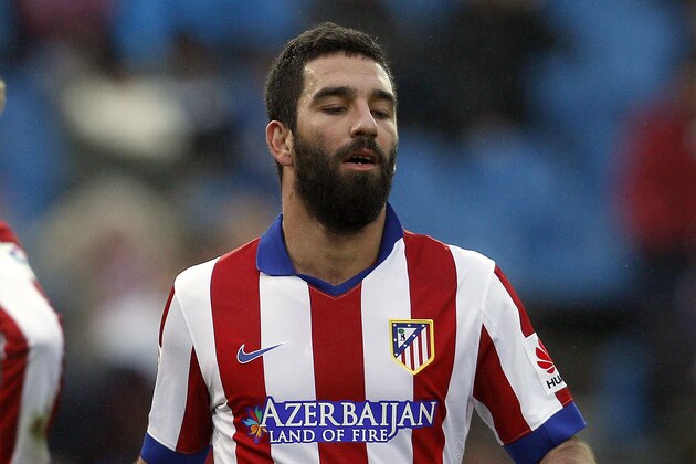 Atletico's Arda Turan, right, and Fernando Torres, left, gesture during a Spanish La Liga soccer match between Atletico Madrid and Granada at the Vicente Calderon stadium in Madrid, Spain, Sunday, Jan. 18, 2015. (AP Photo/Andres Kudacki)