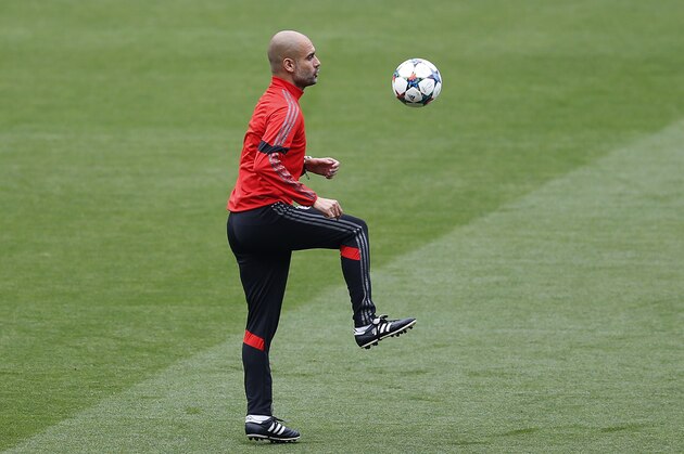 Bayern Munich's coach Pep Guardiola controls the ball during a training session at the Camp Nou stadium in Barcelona, Spain, Tuesday, May 5, 2015.  FC Barcelona will play against Bayern Munich in a first leg semifinal Champions League soccer match on Wednesday May 6. (AP Photo/Manu Fernandez)