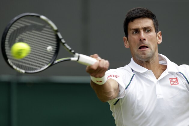 Novak Djokovic of Serbia returns a ball to Kevin Anderson of South Africa during their singles match against at the All England Lawn Tennis Championships in Wimbledon, London, Tuesday July 7, 2015. (AP Photo/Alastair Grant)