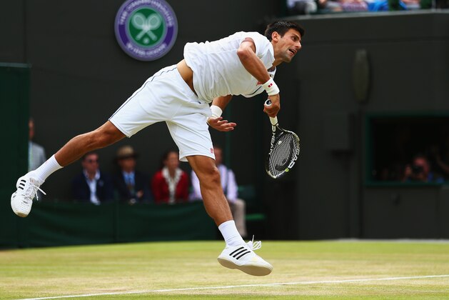 LONDON, ENGLAND - JULY 07:  Novak Djokovic of Serbia serves in his Gentlemens Singles Fourth Round match against Kevin Anderson of South Africa during day eight of the Wimbledon Lawn Tennis Championships at the All England Lawn Tennis and Croquet Club on July 7, 2015 in London, England.  (Photo by Clive Brunskill/Getty Images)