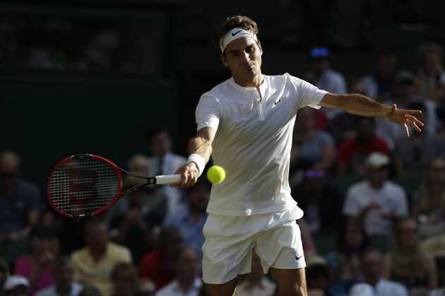 Roger Federer of Switzerland makes a return to Roberto Bautista Agut of Spain during their singles match against at the All England Lawn Tennis Championships in Wimbledon, London, Monday July 6, 2015. (AP Photo/Alastair Grant)
