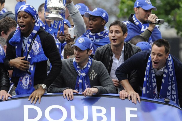 Chelsea's John Terry, right, Frank Lampard, centre right, Petr Cech, centre, and Didier Drogba react, from the top of a bus during a parade, near the Stamford Bridge Stadium, in London, Sunday May 16, 2010. Chelsea overcame a resilient Portsmouth side, to win a dramatic FA Cup final 1-0 and clinch their first League and Cup Double on Saturday. (AP Photo/Tom Hevezi)