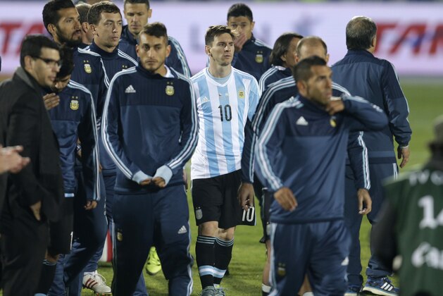Argentina's Lionel Messi stands with his teammates after the Copa America final game agains Chile at the National Stadium in Santiago, Chile, Saturday, July 4, 2015. Chile's goalkeeper Claudio Bravo made a save and striker Alexis Sanchez converted the winning penalty as host Chile defeated Argentina 4-1 in a shootout after a 0-0 draw in the Copa America final.(AP Photo/Natacha Pisarenko)