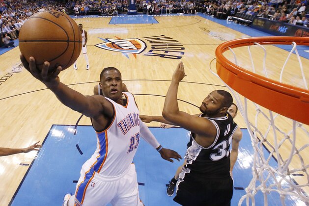 Oklahoma City Thunder guard Dion Waiters (23) goes up for a shot in front of San Antonio Spurs center Boris Diaw (33) during the third quarter of an NBA basketball game in Oklahoma City, Tuesday, April 7, 2015. San Antonio won 113-88. (AP Photo/Sue Ogrocki)