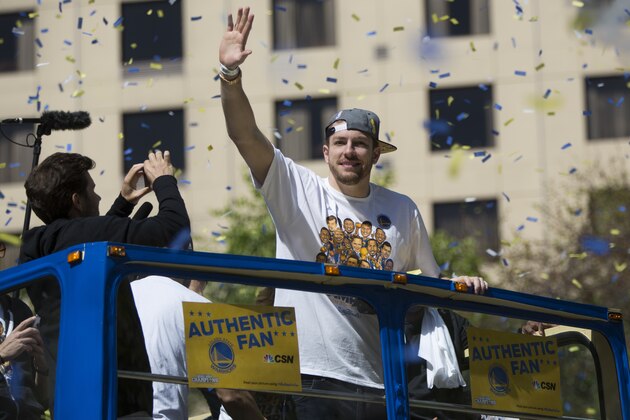OAKLAND, CA - JUNE 19: David Lee #10 of the Golden State Warriors waves to the crowd during the Golden State Warriors Victory Parade in Oakland, California. Thousands are expected to attend in celebration of the Warriors' first NBA title in 40 years. (Photo by Stephen Lam/Getty Images)