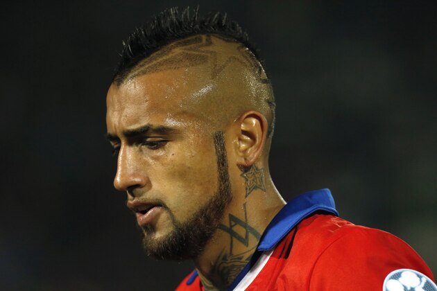 Chile's Arturo Vidal leaves the field after the first half of a Copa America Group A soccer match against Bolivia at El Nacional stadium in Santiago, Chile, Friday, June 19, 2015. Vidal was banned from driving for four months by a Chilean judge on Wednesday after he crashed his Ferrari while driving under the influence of alcohol. Despite the judge's ruling, Chile national team coach Jorge Sampaoli said Vidal would continue to play for the team.(AP Photo/ Luis Hidalgo)