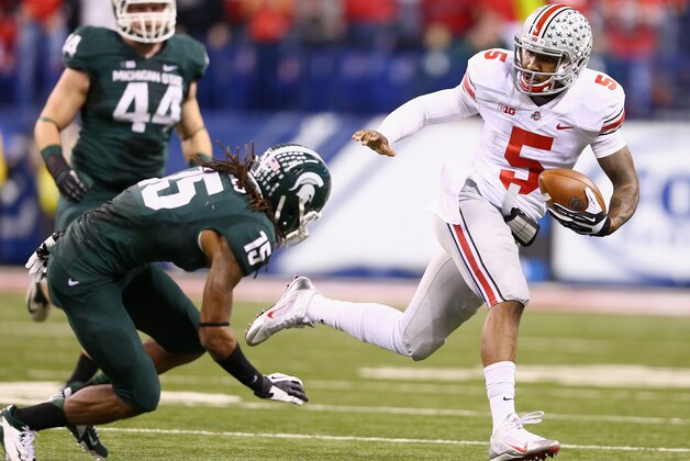 INDIANAPOLIS, IN - DECEMBER 07:  Quarterback Braxton Miller#5 of the Ohio State Buckeyes runs against the defense of Trae Waynes #15 of the Michigan State Spartans during the Big Ten Conference Championship game at Lucas Oil Stadium on December 7, 2013 in Indianapolis, Indiana.  (Photo by Andy Lyons/Getty Images)