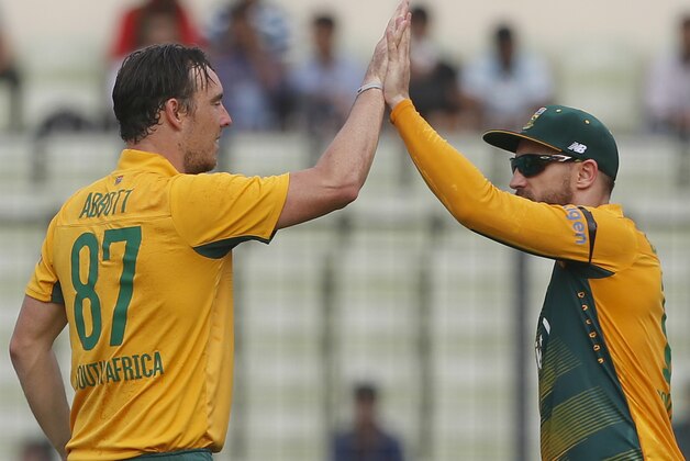 South Africa’s Kyle Abbott, left, celebrates with his team captain Faf du Plessis after the dismissal of Bangladesh’s Mustafizur Rahman during their second Twenty20 international cricket match in Dhaka, Bangladesh, Tuesday, July 7, 2015. (AP Photo/ A.M. Ahad)