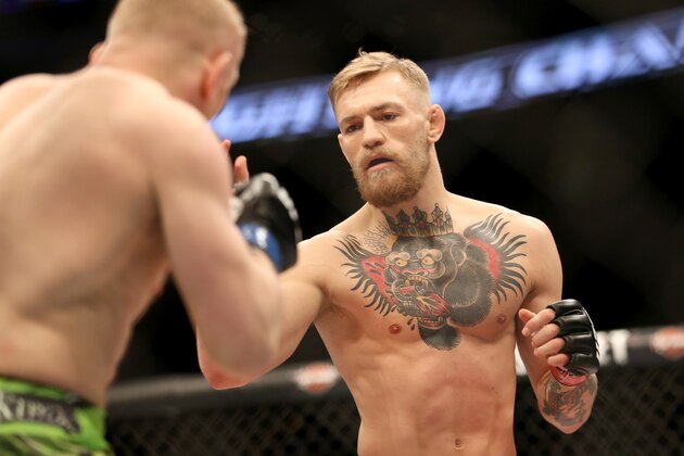 Conor McGregor, right, in action against Denis Siver, during their featherweight fight at UFC Fight Night, Sunday, January 18, 2015 in Boston.  McGregor won via 2nd round TKO. (AP Photo/Gregory Payan)