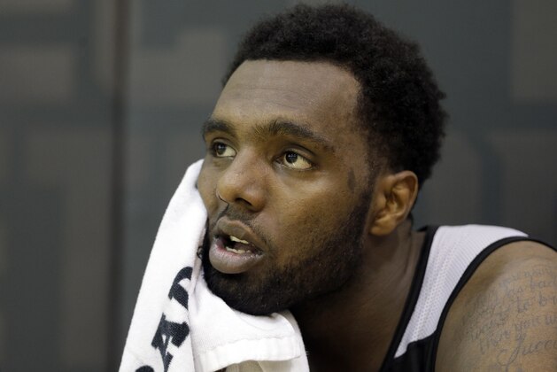 Charlotte Hornets' P.J. Hairston watches players shoot as he cools off after the NBA team's minicamp practice in Charlotte, N.C., Monday, July 7, 2014. Hairston is scheduled to appear in Durham County Court next month on misdemeanor charges of assault and battery following an altercation at a pickup basketball game on Sunday. Paul Sherwin, the public information officer for the Durham County Sheriff's Office, said Hairston, 21, was issued a summons on Monday but will not be arrested. (AP Photo/Chuck Burton)
