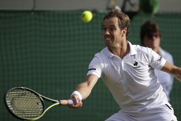 Richard Gasquet of France returns a shot to  Stan Wawrinka of Switzerland during the men's quarterfinal singles match at the All England Lawn Tennis Championships in Wimbledon, London, Wednesday July 8, 2015. (AP Photo/Pavel Golovkin)