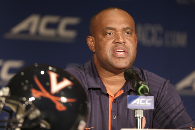 Virginia head coach Mike London answers a question during a news conference at the Atlantic Coast Conference Football kickoff in Greensboro, N.C., Monday, July 21, 2014. (AP Photo/Chuck Burton)