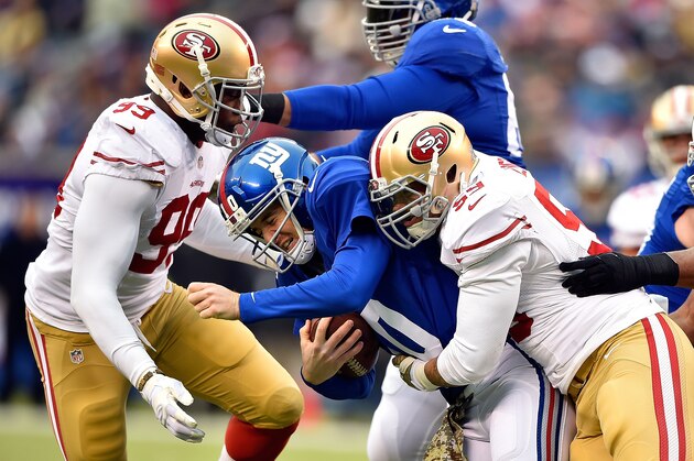 EAST RUTHERFORD, NJ - NOVEMBER 16:  (R-L) Aaron Lynch #59 and  Aldon Smith #99 of the San Francisco 49ers sack  Eli Manning #10 of the New York Giants  at MetLife Stadium on November 16, 2014 in East Rutherford, New Jersey.  (Photo by Al Bello/Getty Images)