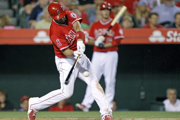 Los Angeles Angels' Albert Pujols hits a two-run home run during the sixth inning of a baseball game against the Arizona Diamondbacks to score Mike Trout in Anaheim, Calif., Tuesday, June 16, 2015. (AP Photo/Alex Gallardo)