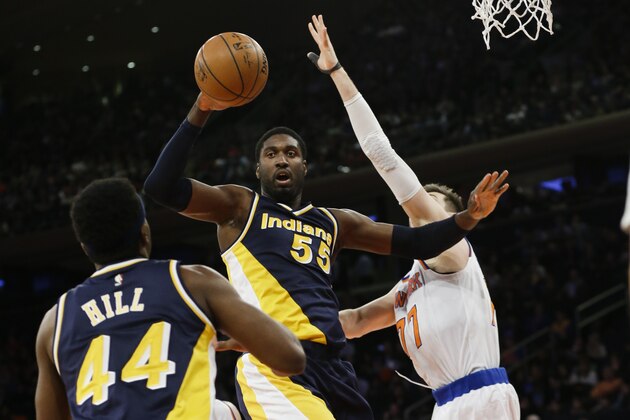 Indiana Pacers' Roy Hibbert (55) passes the ball to teammate Solomon Hill (44) as New York Knicks' Andrea Bargnani (77) defends during the second half of an NBA basketball game Wednesday, April 8, 2015, in New York. (AP Photo/Frank Franklin II)