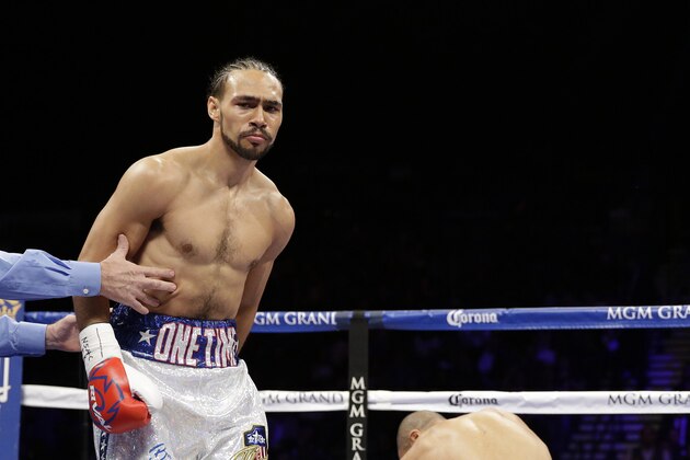 Keith Thurman knocks down Leonard Bundu during their WBA interim welterweight title bout Saturday, Dec. 13, 2014, in Las Vegas. (AP Photo/John Locher)