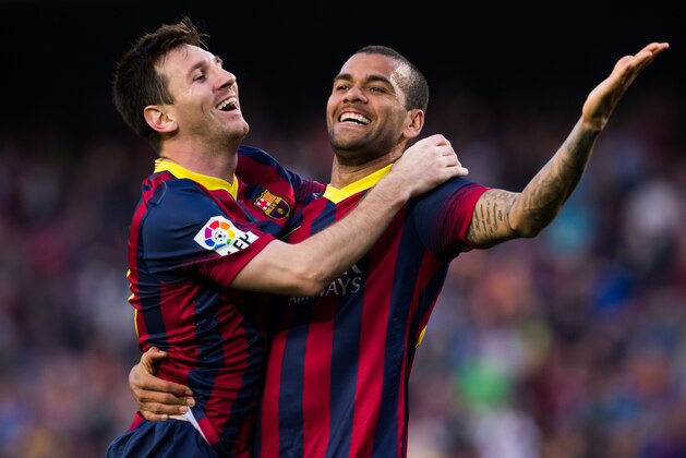 BARCELONA, SPAIN - MARCH 16: Lionel Messi of FC Barcelona celebrates with his teammate Daniel Alves after scoring his team's sixth goal during the La Liga match between FC Barcelona and CA Osasuna at Camp Nou on March 16, 2014 in Barcelona, Spain. (Photo by Alex Caparros/Getty Images)