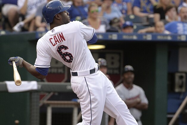Kansas City Royals' Lorenzo Cain follows through on a two-run triple during the fifth inning of a baseball game against the Minnesota Twins on Saturday, July 4, 2015, in Kansas City, Mo. (AP Photo/Charlie Riedel)