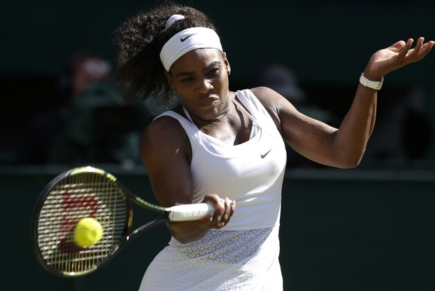 Serena Williams of the United States returns a shot to Maria Sharapova of Russia during the women's singles semifinal match at the All England Lawn Tennis Championships in Wimbledon, London, Thursday July 9, 2015. (AP Photo/Alastair Grant)