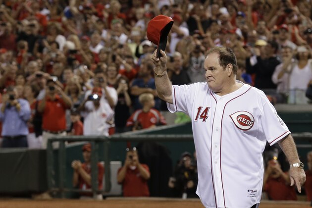 Former Cincinnati Reds great Pete Rose walks onto the field during ceremonies honoring the starting eight of the 1975-76 World Series-champion Reds, following a baseball game between the Reds and the Los Angeles Dodgers, Friday, Sept. 6, 2013, in Cincinnati. (AP Photo/Al Behrman)