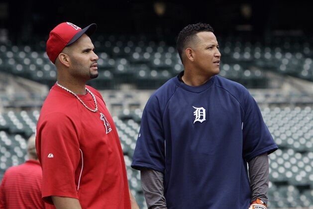 Los Angeles Angels' Albert Pujols, left, and Detroit Tigers' Miguel Cabrera talk before a baseball game in Detroit, Wednesday, June 26, 2013.  (AP Photo/Paul Sancya)