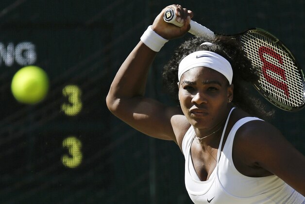 Serena Williams of the United States returns a shot to Maria Sharapova of Russia, during the women's singles semifinal match at the All England Lawn Tennis Championships in Wimbledon, London, Thursday July 9, 2015. (AP Photo/Pavel Golovkin)