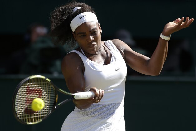 Serena Williams of the United States returns a shot to Maria Sharapova of Russia during the women's singles semifinal match at the All England Lawn Tennis Championships in Wimbledon, London, Thursday July 9, 2015. (AP Photo/Alastair Grant)