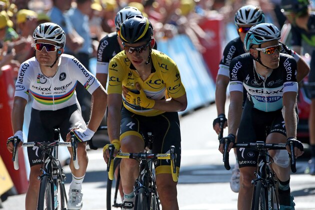 LE HAVRE, FRANCE - JULY 09:  Tony Martin (C) of Germany riding for Etixx-QuickStep in the overall leader yellow jersey arrives at the finish with teammates Michal Kwiatkowski (L) of Poland riding for Etixx-QuickStep and Julien Vermote (R) of Belgium riding for Etixx-QuickStep after Martin was involved in a crash in the final kilometer of stage six of the 2015 Tour de France from Abbeville to Le Havre on July 9, 2015 in Le Havre, France.  (Photo by Doug Pensinger/Getty Images)