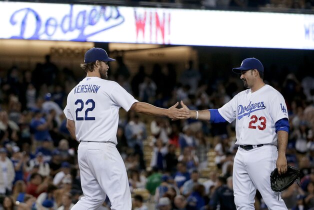 Los Angeles Dodgers starting pitcher Clayton Kershaw, left, celebrates with first baseman Adrian Gonzalez after pitching a shutout against the Philadelphia Phillies during a baseball game in Los Angeles, Wednesday, July 8, 2015. The Dodgers won 5-0. (AP Photo/Chris Carlson)