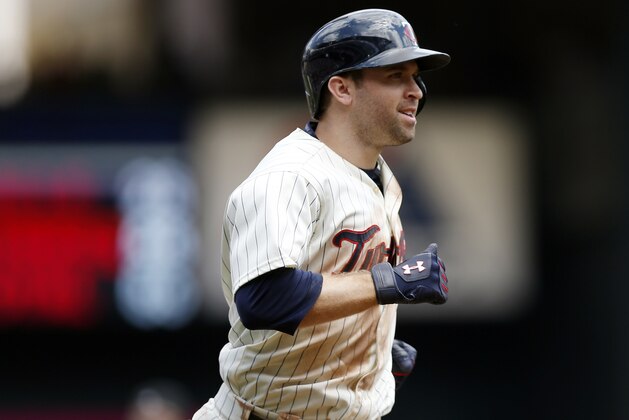 Minnesota Twins'  Brian Dozier in the rounds the bases on a two-run home run off Baltimore Orioles pitcher Bud Norris in the sixth inning of a baseball game, Wednesday, July 8, 2015, in Minneapolis. Twins' Joe Mauer followed with a solo home run off Norris. The Twins won 5-3, sweeping the three-game series. (AP Photo/Jim Mone)