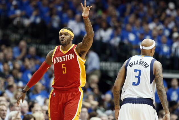 Houston Rockets' Josh Smith (5) celebrates his 3-point basket in front of Dallas Mavericks' Charlie Villanueva (3) in the second half of Game 3 in an NBA basketball first-round playoff series Friday, April 24, 2015, in Dallas. The Rockets won 130-128. (AP Photo/Tony Gutierrez)