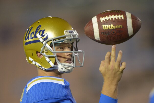 UCLA quarterback Jerry Neuheisel twirls a ball as they warm up prior to their NCAA college football game against California, Saturday, Oct. 12, 2013, in Pasadena, Calif. (AP Photo/Mark J. Terrill)